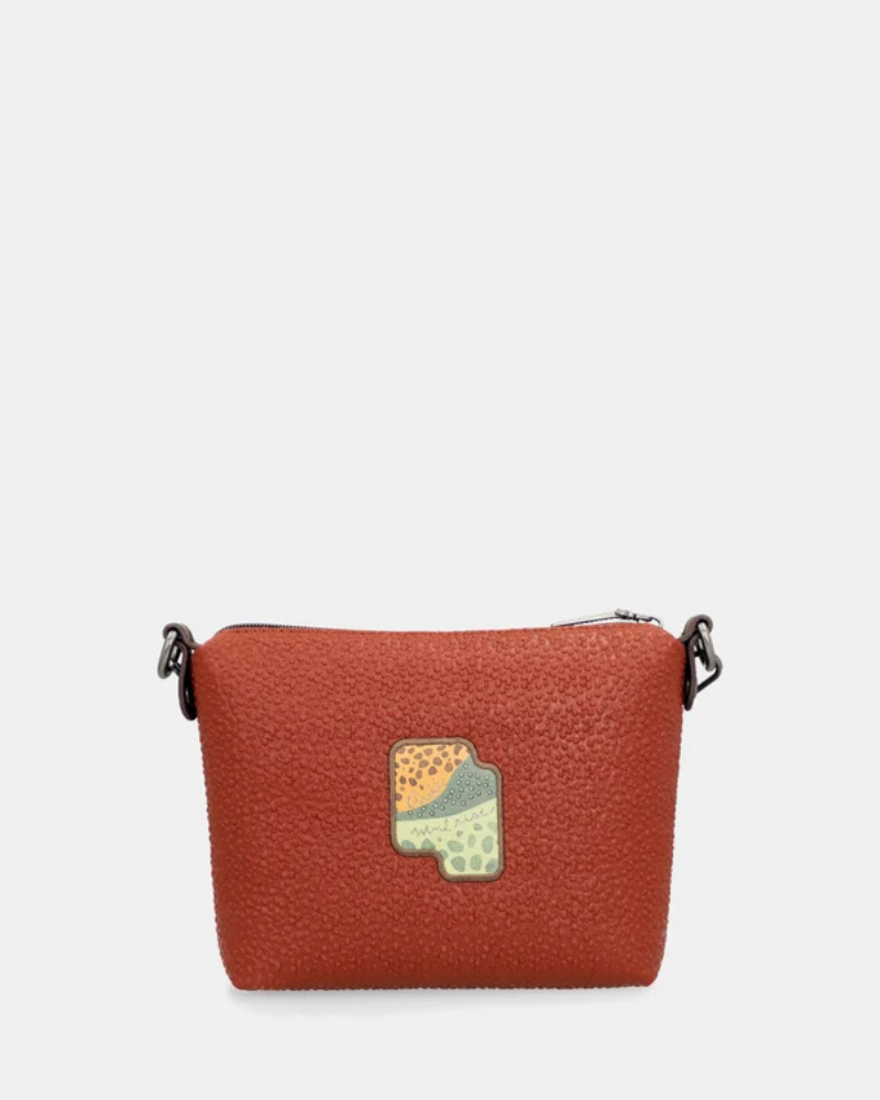 Esta carteira redefine o conceito de versatilidade com uma proposta única: duas carteiras numa só.

A bolsa principal impressiona pelo seu padrão artístico em tons de laranja, verde, bege e terracota, com uma textura trabalhada que evoca o espírito aventureiro e cosmopolita da coleção Odyssey. Os detalhes em metal gunmetal, a corrente com pendente em forma de nuvem e as alças em couro sintético castanho-escuro completam um visual rico e distinto.