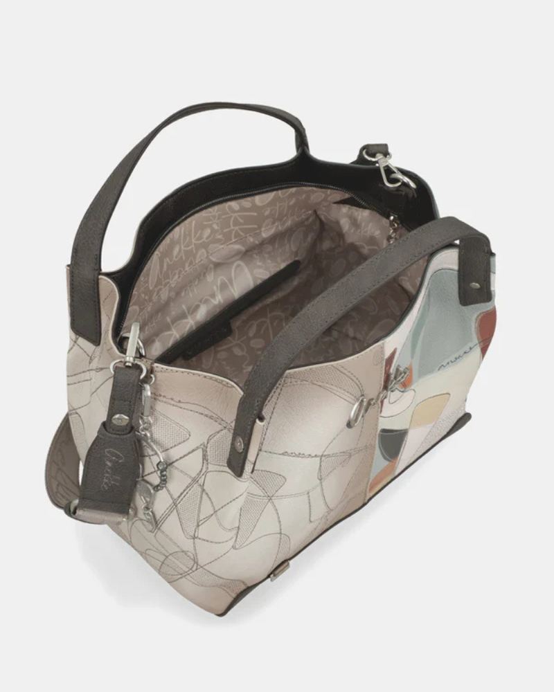 A carteira Auralis é a companheira perfeita para quem procura versatilidade sem comprometer o estilo.

Com um design contemporâneo que combina tons neutros e detalhes coloridos, esta peça destaca-se pela sua construção em materiais de qualidade premium e acabamentos cuidados. As alças curtas permitem um transporte confortável à mão, adaptando-se facilmente ao seu dia a dia, seja num encontro casual ou numa ocasião mais formal.