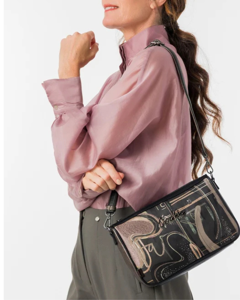 Uma peça que equilibra arte e funcionalidade.

Com um design gráfico exclusivo em tons de preto, bege e dourado envelhecido, esta carteira a tiracolo destaca-se pelo painel frontal com motivos caligráficos e detalhes em strass que captam a luz com subtileza.