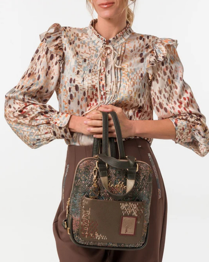 Uma mochila que eleva o conceito de acessório funcional a verdadeira peça de autor.

O seu exterior apresenta um padrão em patchwork com texturas e motivos em tons de verde-musgo, castanho, terracota e dourado, com apontamentos florais e geométricos que evocam a riqueza dos tecidos artesanais. A assinatura Anekke em lettering dourado, os detalhes em metal dourado e o pendente com logótipo completam um design sofisticado e inconfundível.