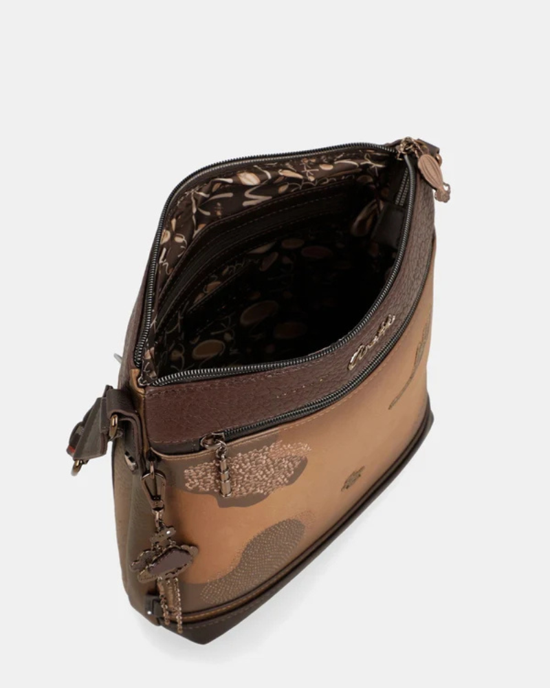 Esta carteira combina elegância discreta com um espírito de aventura.

Em tons camel e bege com base em verde escuro e detalhes em textura croc, esta carteira tem uma sofisticação natural que se adapta tanto a um look casual como a uma ocasião mais cuidada. A silhueta quadrada e estruturada, com bolso frontal com fecho de correr, organiza o essencial com estilo, enquanto a alça de tiracolo com padrão estampado — um toque de personalidade Anekke — permite usá-la ao ombro ou a tiracolo.