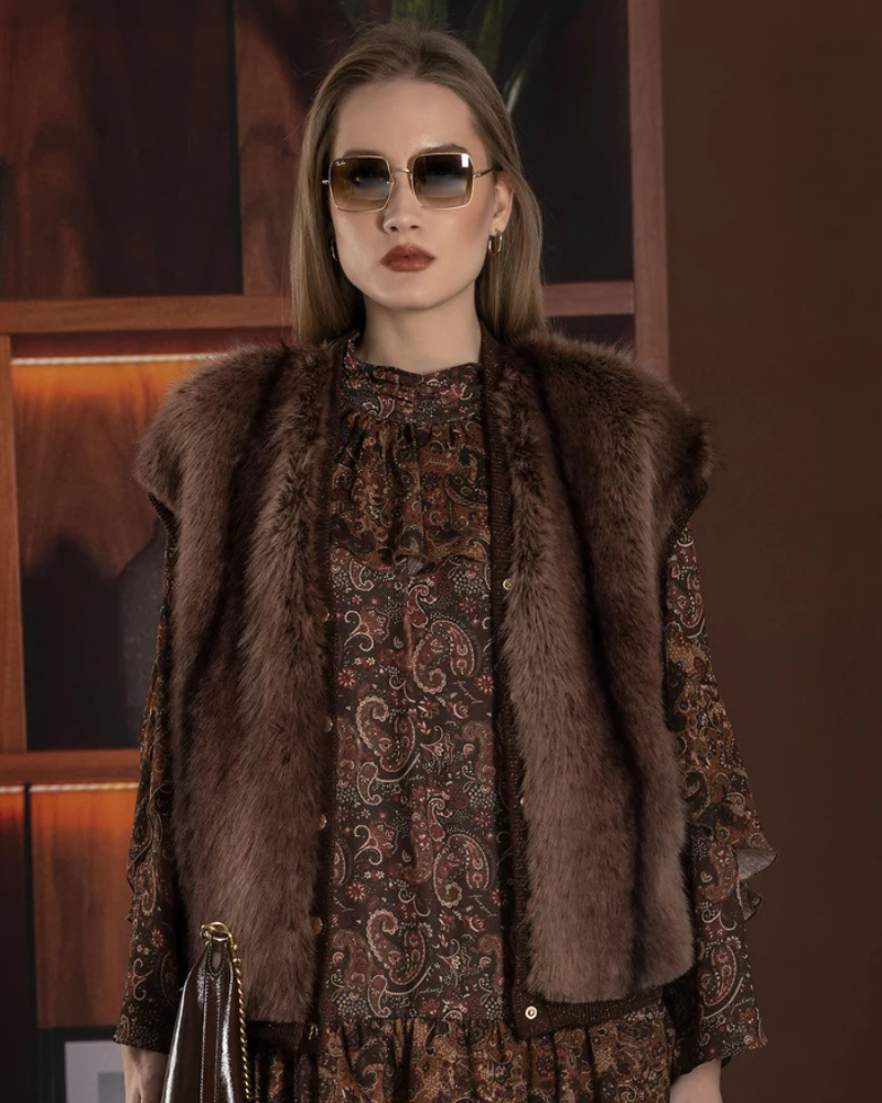 Este colete castanho com efeito de pêlo é uma peça elegante e versátil.

Perfeito para acrescentar textura e personalidade aos looks de outono e inverno. Com corte sem mangas, decote em V e acabamento de pelo macio em tom castanho mesclado, apresenta uma silhueta confortável e fácil de combinar com camisolas, camisas ou vestidos.