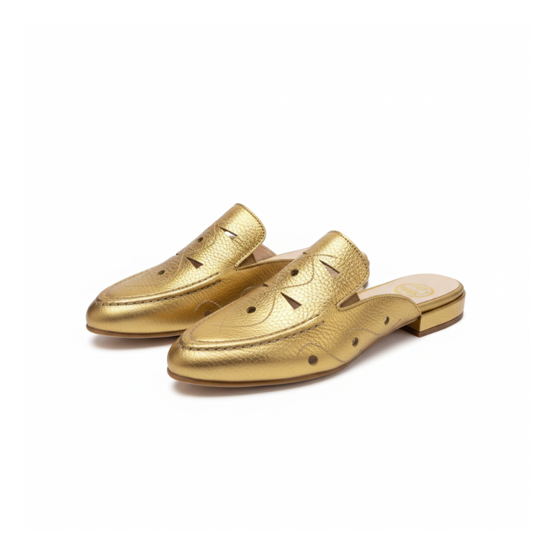 Brilhe com confiança com esta mule loafer em couro metalizado dourado, a peça que transforma qualquer look num momento de puro glamour.

Os detalhes perfurados ao longo do peito do pé adicionam textura e sofisticação ao design, criando um jogo visual interessante que eleva o conceito clássico do loafer. O salto bloco baixo em tons naturais cria um contraste harmonioso com o dourado vibrante, garantindo conforto para usar durante todo o dia.